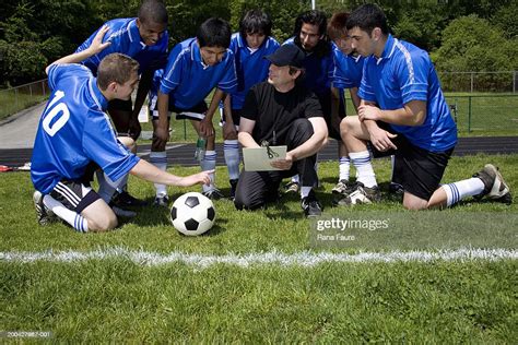 Coach Instructing Teenage Male Soccer Players High Res Stock Photo