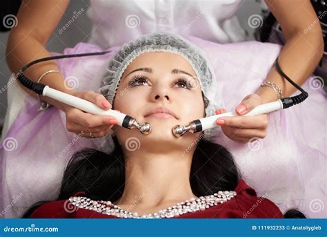 Female Patient Is Having Facial Massage In A Beauty Salon Cosmetology And Skin Care Routine