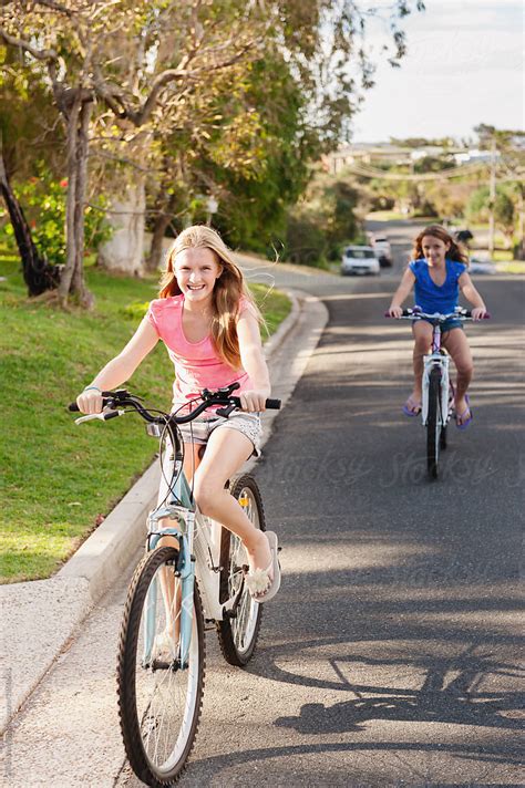 Tween Girls Riding Bikes On The Street By Gillian Vann