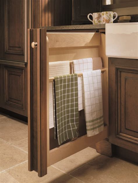 Shelves that fold into each other and then swing out when the cabinet door opens, revealing a deep storage system. Slim Base Pull Out Towel Cabinet | Custom kitchen cabinets ...