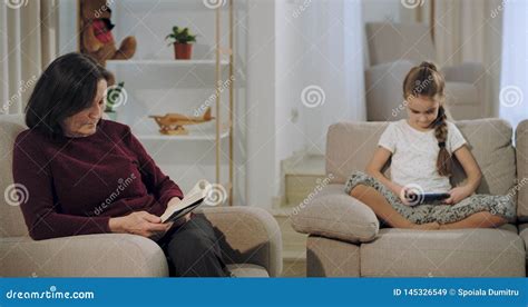 Beautiful Granny With Her Niece Spending A Time Together In Living Room