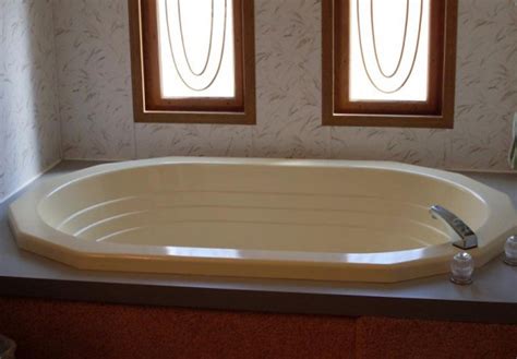 So we used a vinyl flooring remnant that cost $25 used some addesive to help hold while nailing up vinyl covered trim with rust proof nails. Bathtub Surround for Mobile Home | Mobile Homes Ideas