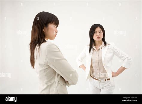 Two Businesswomen Glaring At Each Other Stock Photo Alamy