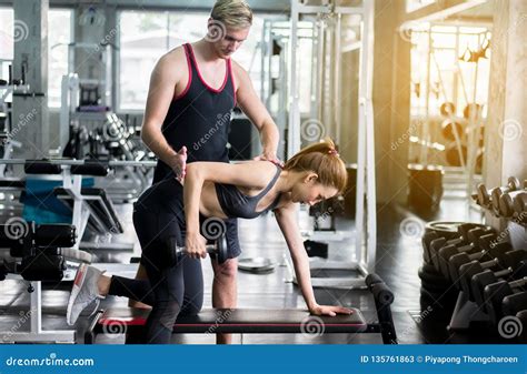 personal trainer coaching woman exercise workout in gym concept healthy