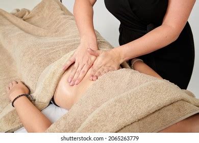Professional Masseuse Massaging Her Female Client Stock Photo
