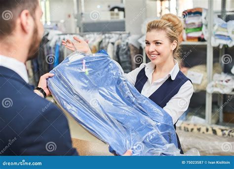 Girl Worker Laundry Man Gives The Client Clean Clothes Stock Image