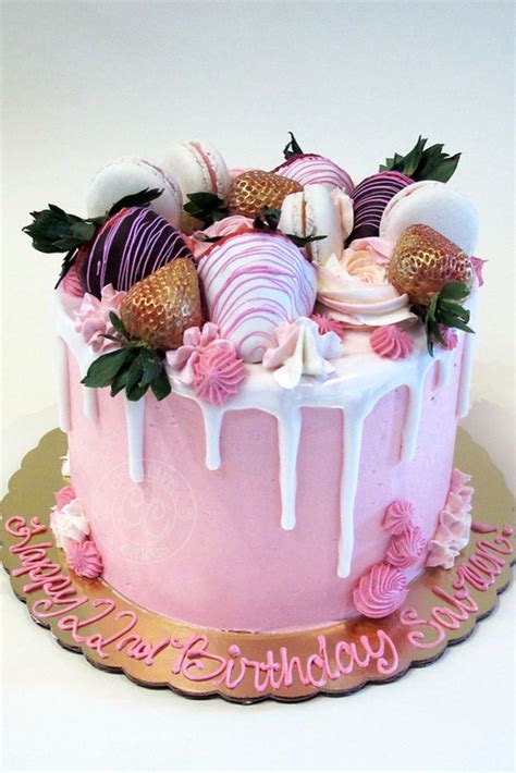 pink drip cake with chocolate covered strawberries by creative cakes bakery in tinley park and