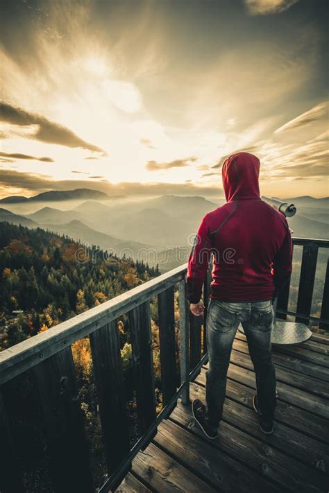 Man On Top Of Mountain During Sunset Conceptual Scene Stock Photo