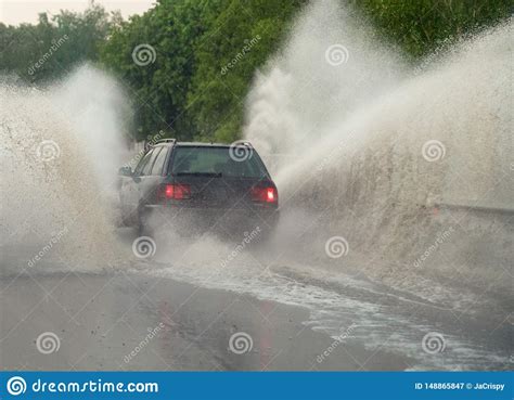 Car Runs Into Big Puddle At Heavy Rain Water Splashing