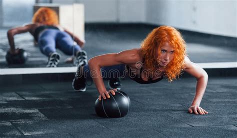 Doing Push Ups With Ball Sporty Redhead Girl Have Fitness Day In Gym