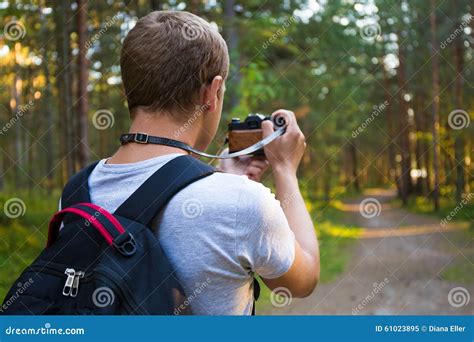 Back View Of Man Taking A Photo With Retro Camera Stock Photo Image