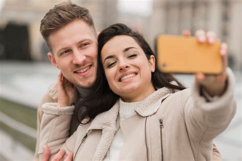 Free Photo Happy Couple Taking A Selfie Outside
