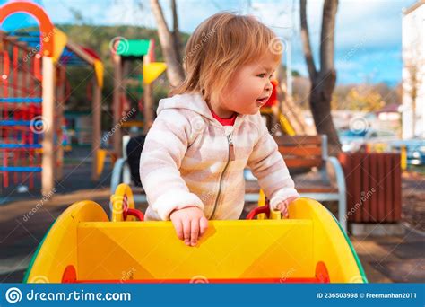Portrait Of A Little Cute Girl Playing A Children S Slide On The