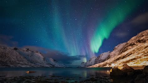 Aurora Sky Over Winter Mountains And Lake