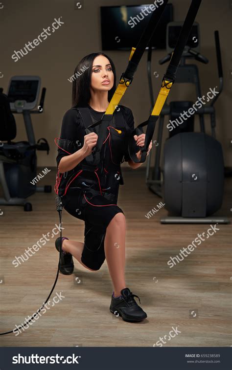 Brunette Girl Electrical Muscular Stimulation Suit Stock Photo