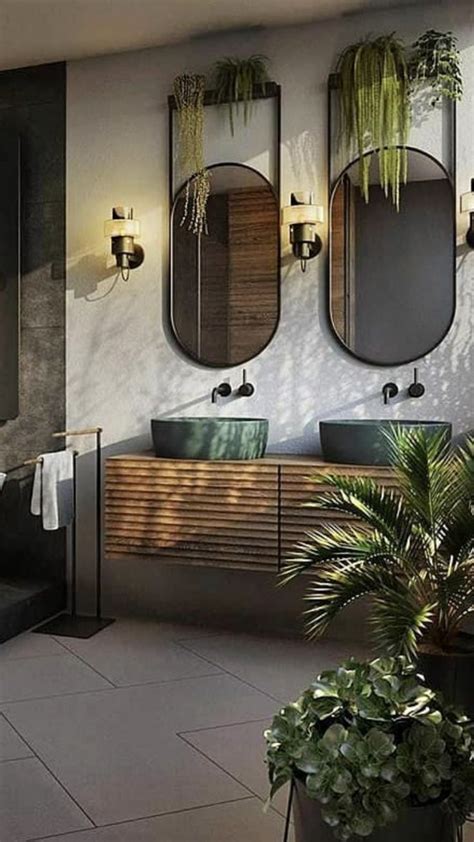 A Bathroom With Two Sinks And Three Mirrors On The Wall Next To A Bathtub