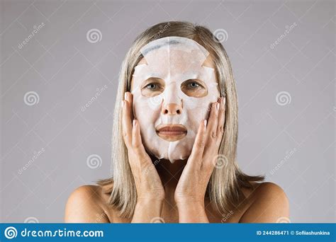 senior woman using cotton face mask for skin care stock image image of positive perfection