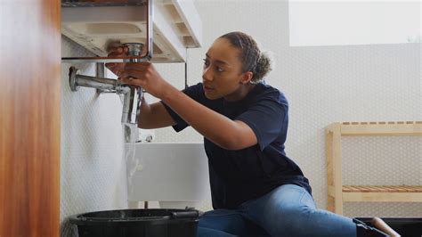 Female Plumber Working To Fix Leaking Sink In Home Bathroom Stock Video Footage Storyblocks