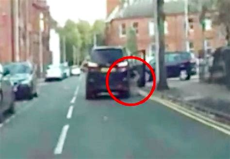 Footage Shows Woman Being Dragged Along Road By Car Thief