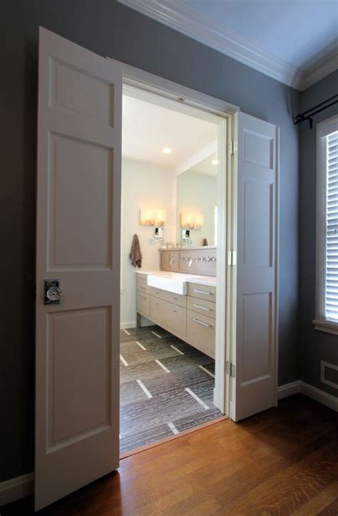 An Open Door Leading To A Bathroom With Wood Floors