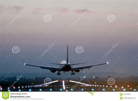 Rear View Of A Plane Taking Off From A Runway At An