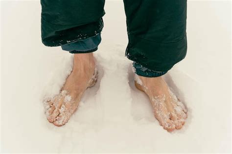 Premium Photo Mens Bare Feet Are Standing On The Snow