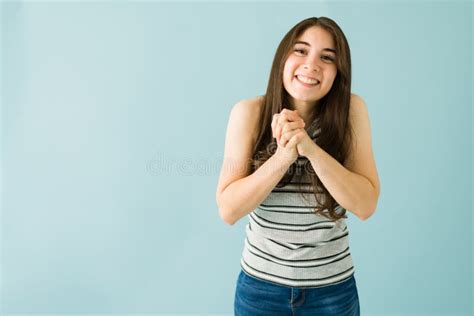 Young Woman With Her Hands Together Asking For A Favor Stock Photo
