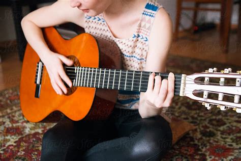 Young Woman Playing The Guitar By Stocksy Contributor Danil Nevsky