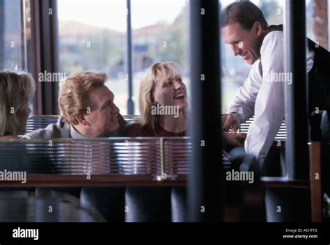 Waiter Taking Order From Caucasian Couple In Restaurant Stock Photo Alamy