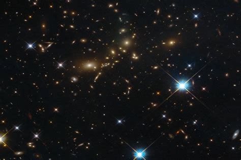 Colossal Distant Galaxy Cluster Captured By Hubble Space Telescope