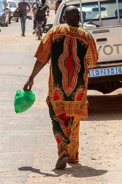 Unidentified Senegalese Man In Traditional Clothes Walks From B