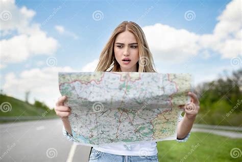 Shocked Young Blonde Woman Hitchhiking On Road Checking Map Feeling Lost And Confused