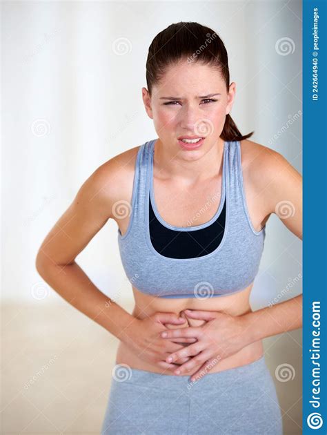 Stomach Ache Portrait Of An Attractive Young Woman Holding Her Stomach