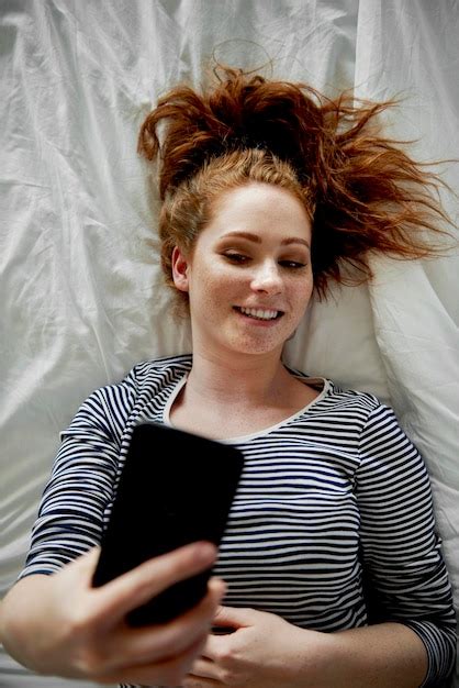 Premium Photo Top View Of Woman On Bed Taking A Selfie