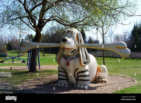 White Plastic Dog Holding Bone At Playground Stock Photo Alamy