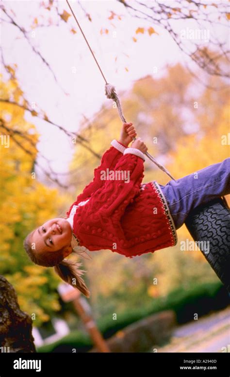 Young Girl On Tire Swing Stock Photo Alamy