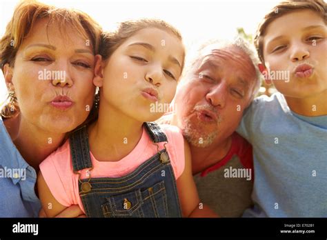 Portrait Of Grandparents And Grandchildren In Garden Stock Photo Alamy