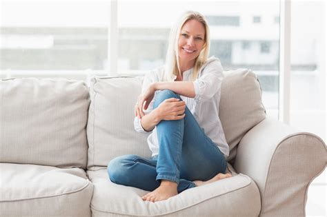 Portrait Of Happy Woman Sitting On Sofa All Brite Cleaning Restoration