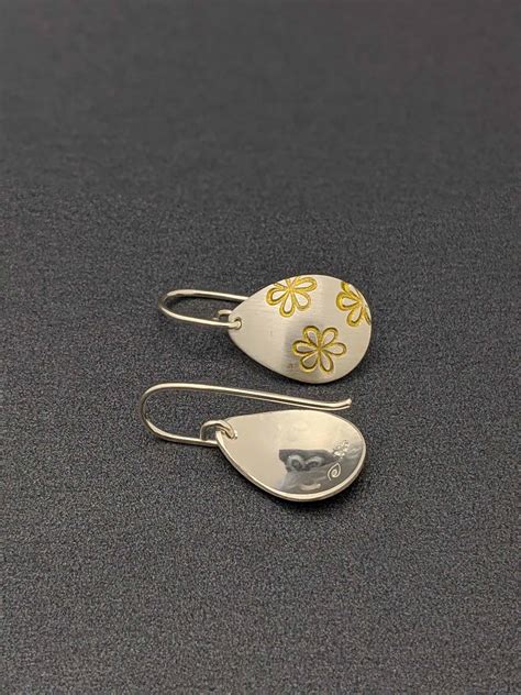 A beautiful precious metal which is good for sensitive ears. handmade-sterling-silver-teardrop-earrings-daisy-stamped