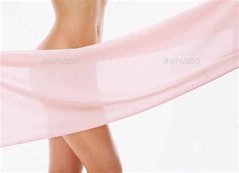 Soft And Sensual Cropped Studio Shot Of Pink Material Masking A Womans Naked Body Stock Photo