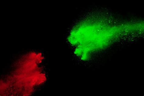 Premium Photo Red And Green Powder Explosion On Black Background