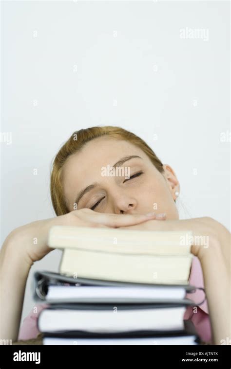 Young Woman Leaning On Stack Of Books Eyes Closed Stock Photo Alamy