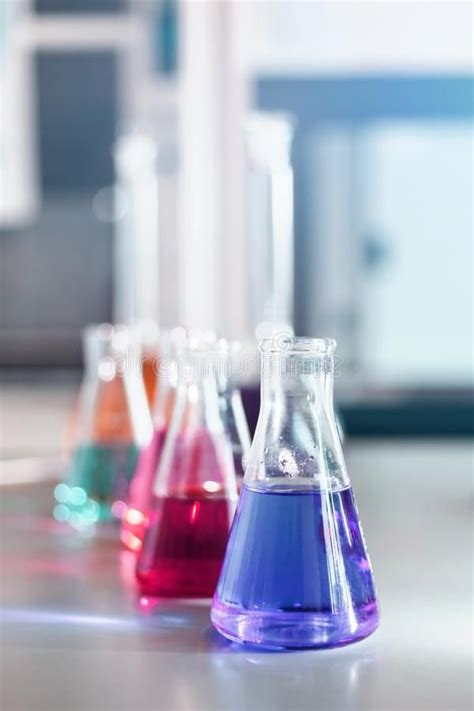 Chemical Laboratory Flask With Blue Purple Pink Liquid Stand On The