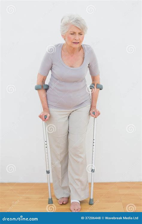 Full Length Of A Senior Woman With Crutches Stock Photo Image Of