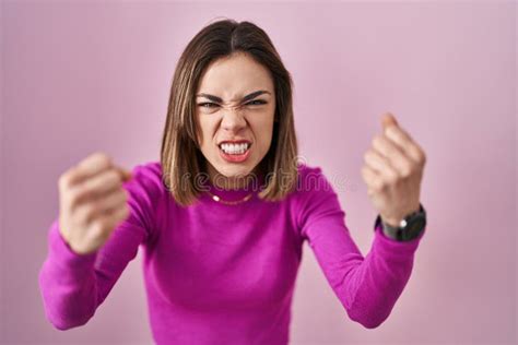 Hispanic Woman Standing Over Pink Background Angry And Mad Raising