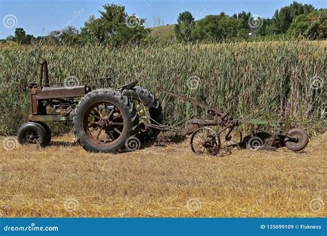 Old John Deere Tractor And Two Bottom Plow Editorial Stock Image