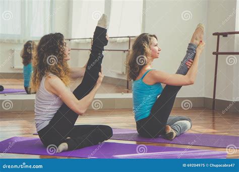 Two Fit Pretty Women Are Stretching Legs Together Stock Image Image