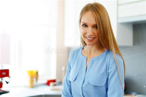 blonde woman standing in kitchen and cooking stock image image of woman slim 193458119