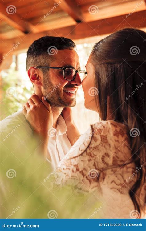 Close Up Portrait Of Newlywed Couple Caressing And Kissing On Their
