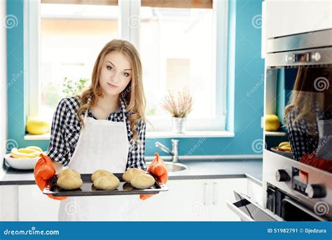 Housewife Holding Hot Roasting Pan With Freshly Baked Bread Rolls